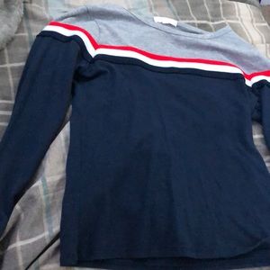 A long sleeve shirt with Red, White and blue strip